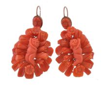 ϒ A pair of coral earrings, each carved with an infant among foliage, with shepherd's hook fittings,