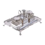 A silver shaped rectangular inkstand by The Goldsmiths & Silversmiths Co. Ltd, London 1910, with a