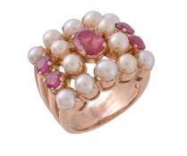 A cultured pearl and ruby dress ring, the central oval cut ruby within a surround of cultured pearls