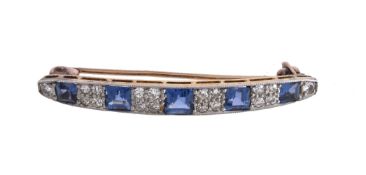 An early 20th century sapphire and diamond brooch, the slightly curved panel set with square cut