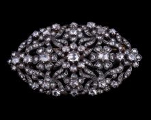 A mid 19th century diamond brooch, the oval pierced gold backed silver foliate panel set with rose