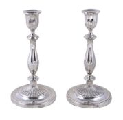 A pair of English circular candlesticks, apparently unmarked, circa 1790, with part fluted capitals,
