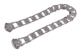 An Edwardian silver panelled belt by King & Sons, Chester 1902, with a two-part scroll cast