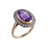 An amethyst and diamond ring, the oval cut amethyst collet set within a surround of eight cut