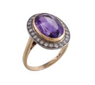 An amethyst and diamond ring, the oval cut amethyst collet set within a surround of eight cut