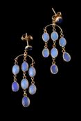 A pair of opal and sapphire earrings, the circular cabochon sapphire suspending a fringe of oval