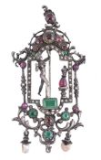 An early 20th century gem set brooch/pendant, the openwork scrolling panel with a central figure,