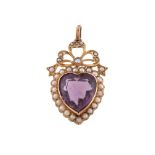 An Edwardian amethyst and seed pearl pendant, the heart shaped amethyst within a surround of seed