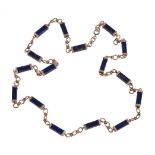 A 1970s lapis lazuli and gold coloured necklace, the rectangular lapis batons with gold coloured