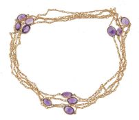 A gold coloured amethyst long chain, the fancy link chain set with oval cut amethysts, 155cm long,