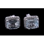 A pair of aquamarine and diamond earrings, the rectangular cut aquamarine in a four claw setting,
