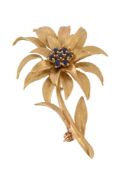 A 1960s 18 carat gold sapphire brooch, designed as a flower set with a cluster of circular cut