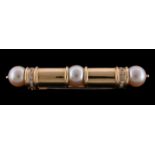 A cultured pearl and diamond brooch by Ansuini, the baton shaped brooch centrally set with a