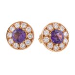 A pair of amethyst and diamond earrings, the circular cut amethyst claw set within a surround of