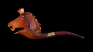 A meerschaum cheroot pipe, early 20th century, carved as a horse's head, with an amber mouthpiece,