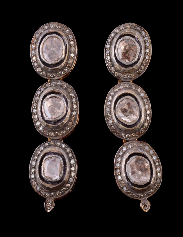 A pair of diamond earrings, the ear pendants set with lasque diamonds each within a surround of
