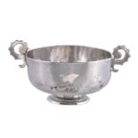 A silver twin handled cup, unmarked, probably English late 17th century, with shaped scroll handles,