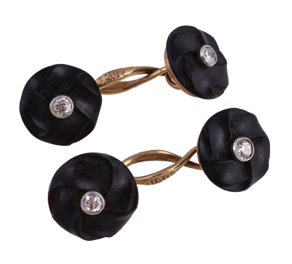 A pair of black stone and diamond cufflinks, the carved stone panels each set with an old