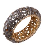 A diamond bracelet, the pierced bangle set with polki diamonds, 6.2cm inner width, 90g