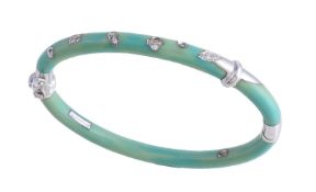 A resin and diamond hinged bangle by La Nouvelle Bague, the green resin bangle inlaid with brilliant