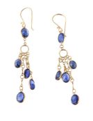 A pair of sapphire ear pendants, set with a fringe of oval cut sapphires, suspended from a further