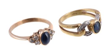 A sapphire and diamond ring, the oval cabochon sapphire collet set between two trios of brilliant
