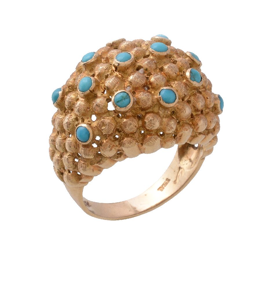 A 1970s turquoise bombé dress ring, set with circular cabochon turquoise on a textured beaded