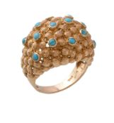 A 1970s turquoise bombé dress ring, set with circular cabochon turquoise on a textured beaded