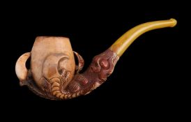 A meerschaum pipe, early 20th century, carved as an eagle's talon holding an egg, with an amber