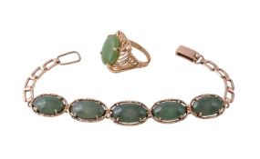 A serpentine bracelet, set with oval cabochon serpentine, to the ladder link clasp, stamped 14K,
