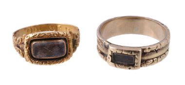 A Georgian 18 carat gold mourning ring, the glazed panel with plaited hair beneath, within a black