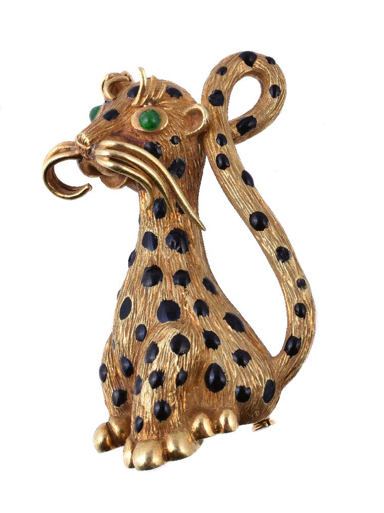 A 1960s enamel cheetah brooch, the textured seated cheetah with black enamel spots and green paste