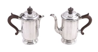 A pair of silver café au lait pots by Mappin & Webb, Birmingham 1928, with composition finials and