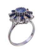 An 18 carat gold sapphire and diamond cluster ring, the central oval cut sapphire claw set within