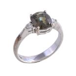 An alexandrite and diamond ring, the oval cut alexandrite claw set between brilliant cut diamonds,