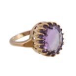 An 18 carat gold amethyst ring, the oval cut amethyst and in a claw setting, stamped 750 with full