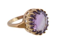 An 18 carat gold amethyst ring, the oval cut amethyst and in a claw setting, stamped 750 with full