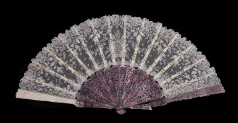 ϒ A lace fan, French, third quarter 19th century, the stained mother of pearl guards scroll pierced,