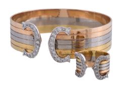 A three colour diamond bangle, the reeded bangle with diamond set C shaped terminals,