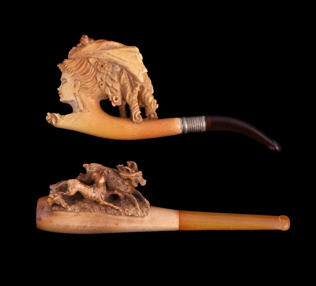 Two meerschaum cheroot pipes, each circa 1900, the first carved as a lady's head, the second with