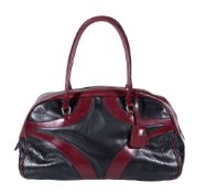 Prada, a burgundy and black leather handbag