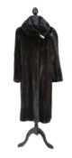 A full length dark mink coat by Laura