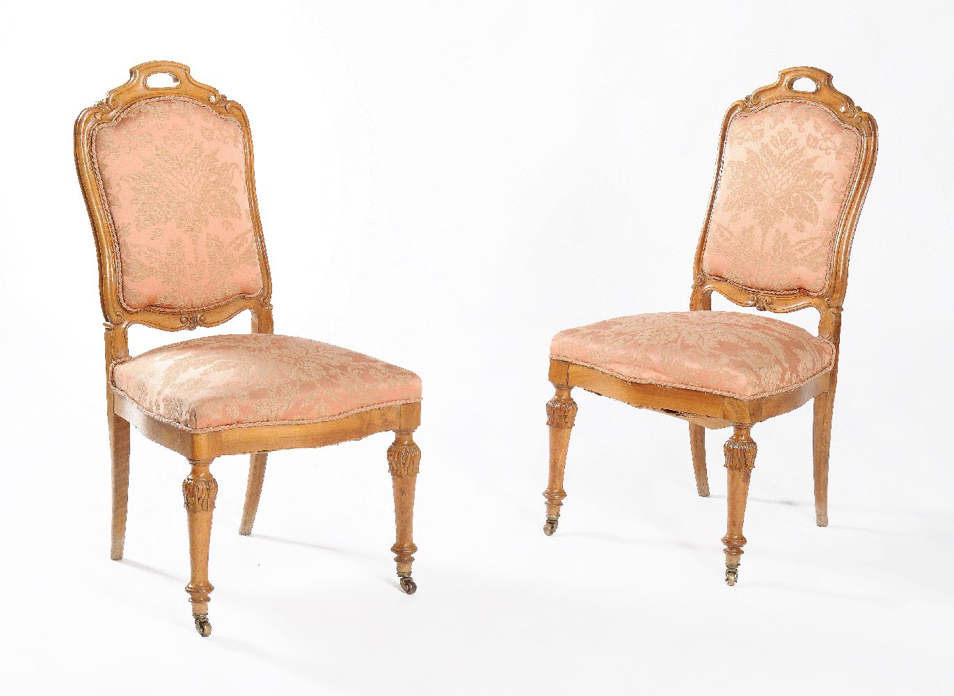 A set of eleven carved walnut and damask upholstered dining chairs