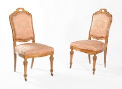 A set of eleven carved walnut and damask upholstered dining chairs
