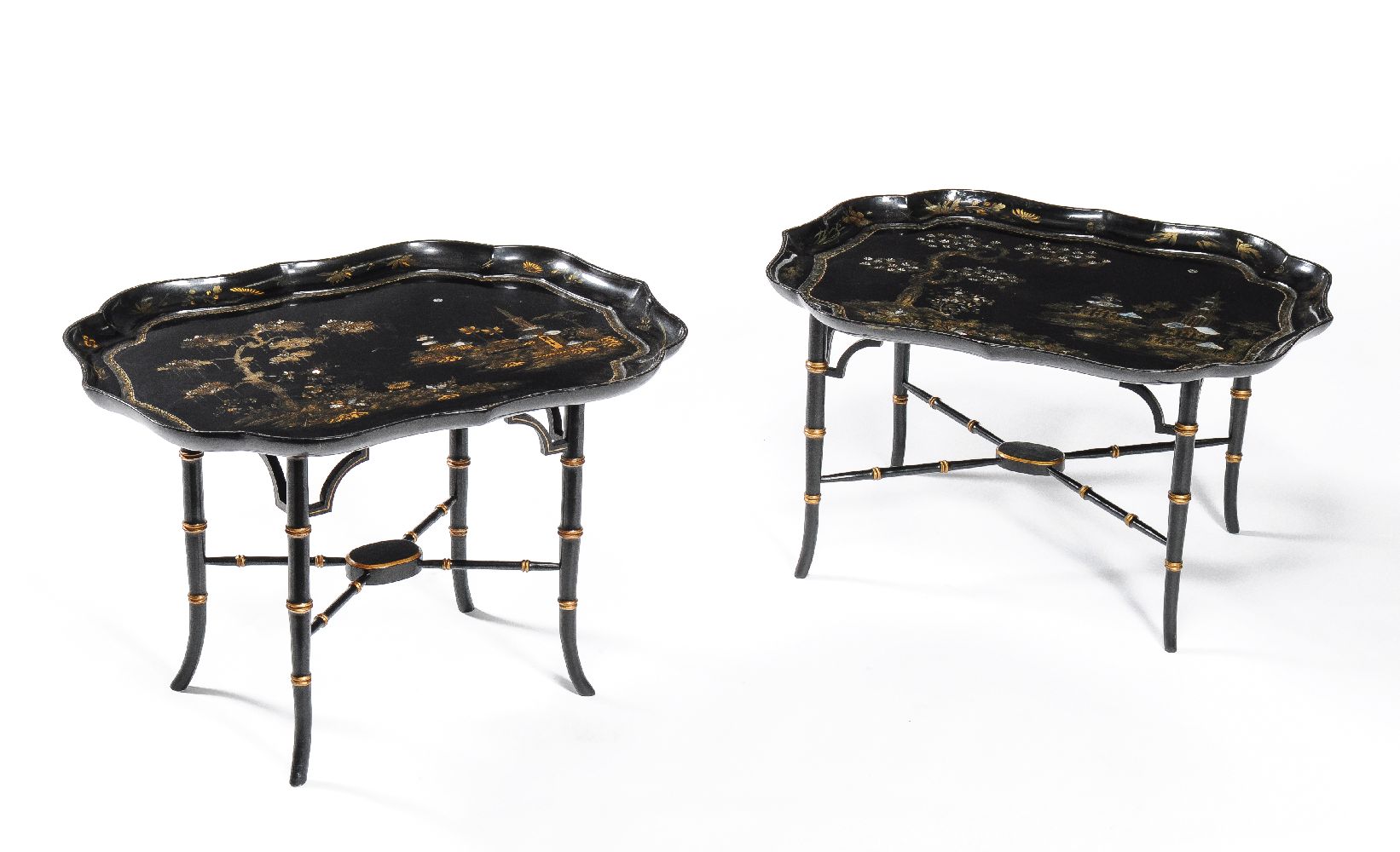 ϒ A companion pair of black lacquered papier mache and mother of pearl inlaid trays on stands