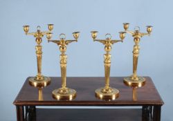 A set of four Empire ormolu twin light candelabra