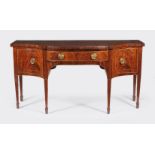 ϒ A George III mahogany serpentine fronted sideboard