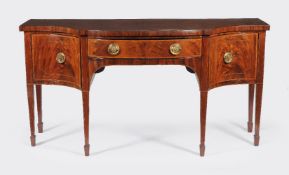 ϒ A George III mahogany serpentine fronted sideboard