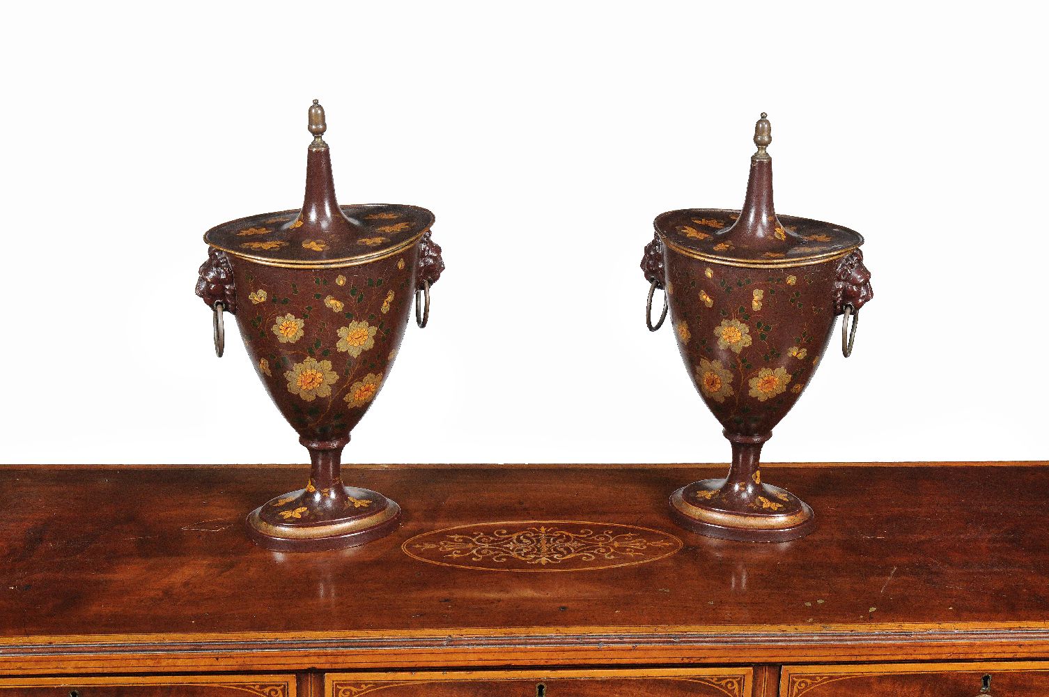 A pair of tôle peinte chestnut urns in Empire style