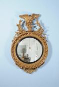 A George III carved giltwood and composition convex wall mirror